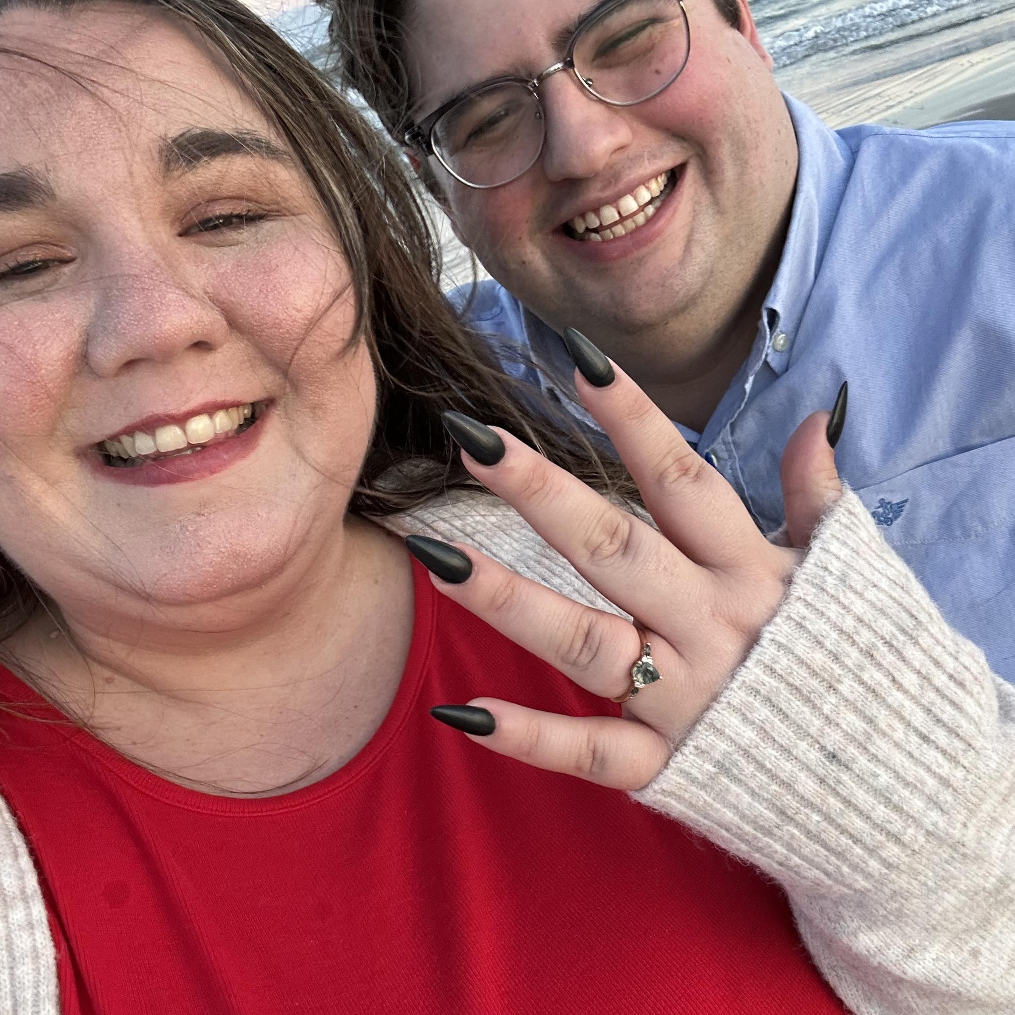 Ashley showing her engagement ring beside Robert.